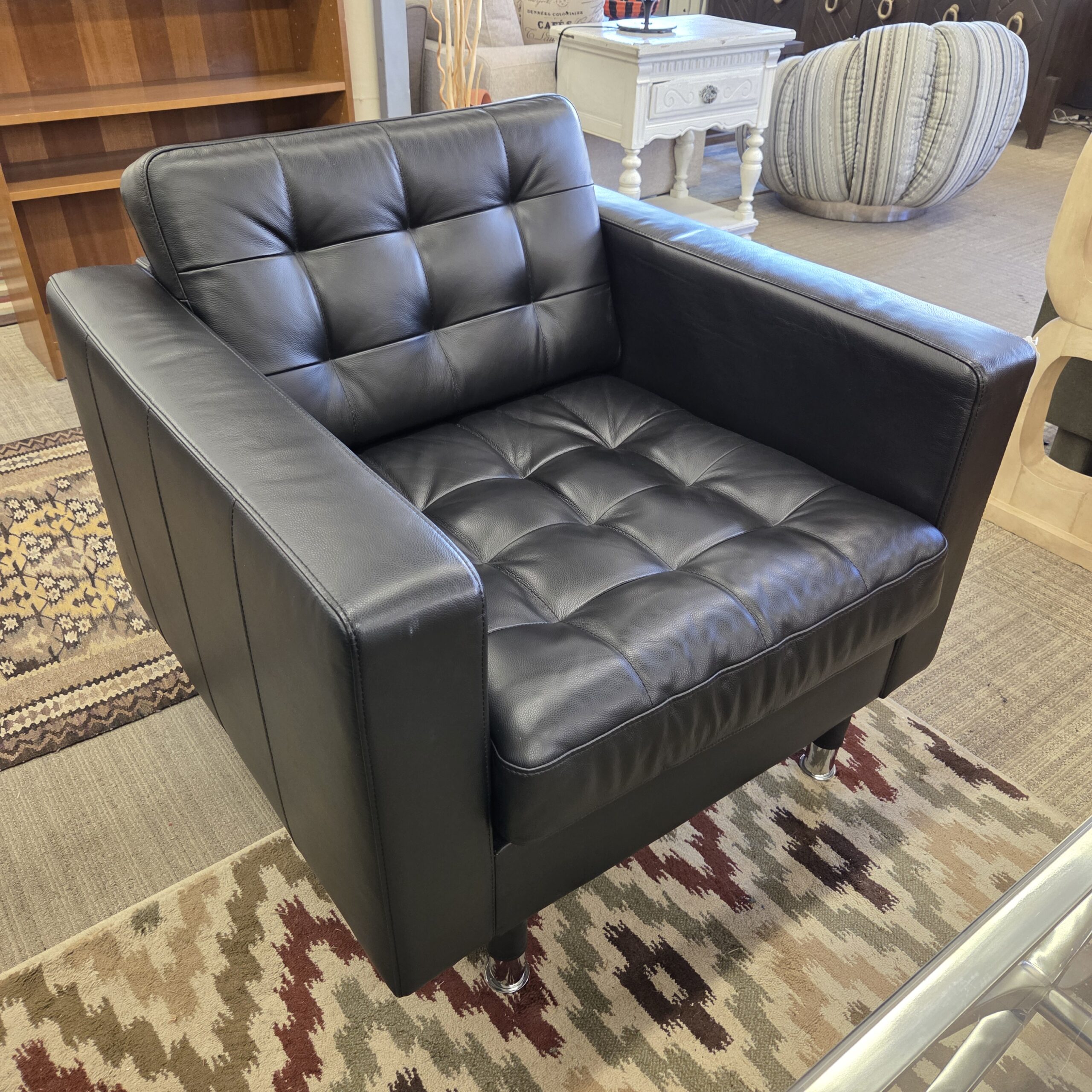 black leather tufted armchair