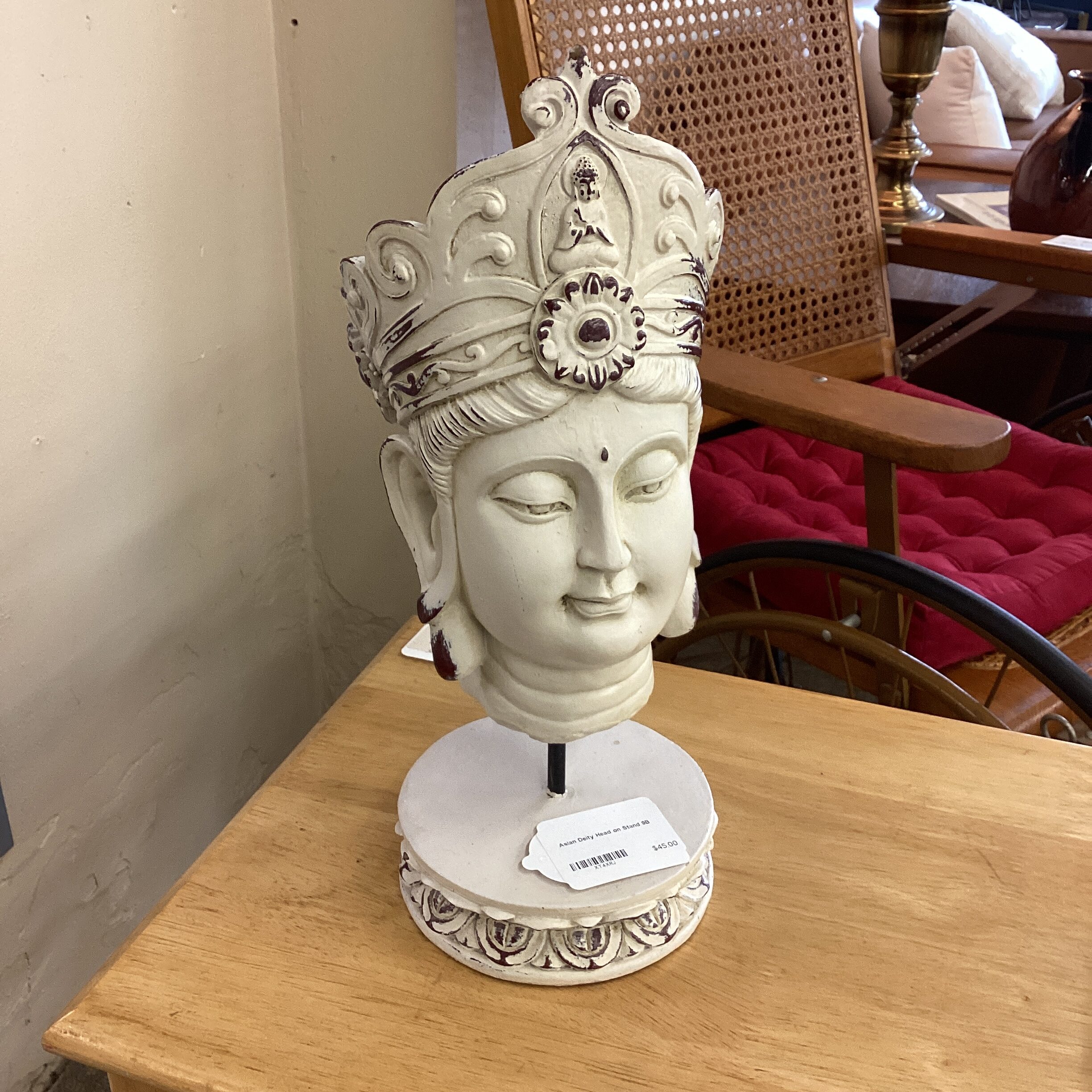 asian deity head on stand