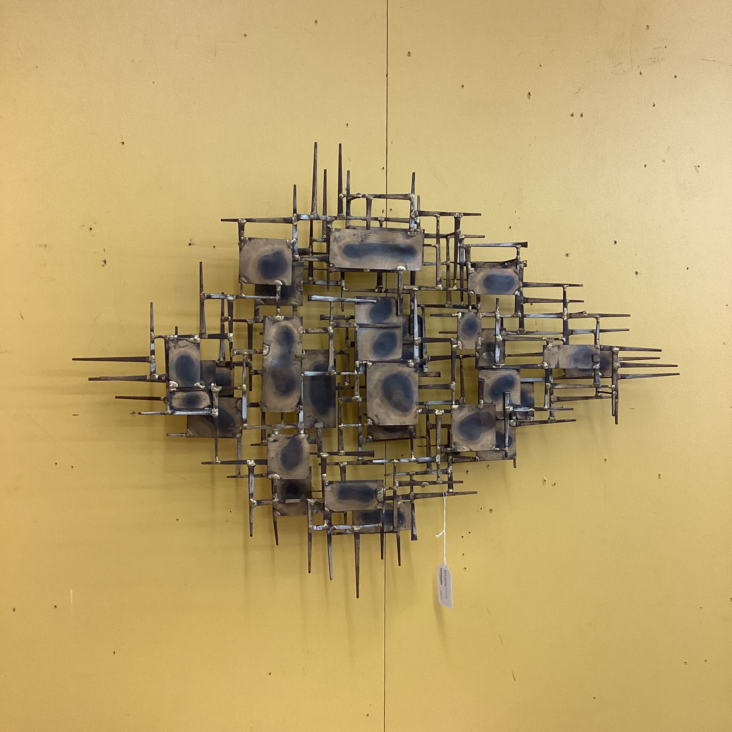marc creates brutalist nails wall sculpture